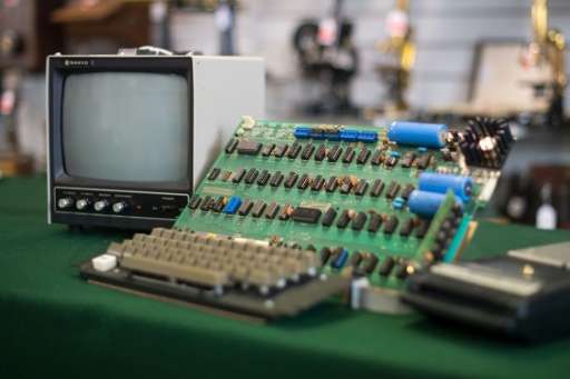 An antique Apple Computer 1 from 1976, one of just eight still working, fetched 110,000 euros at auction in Germany, below a for