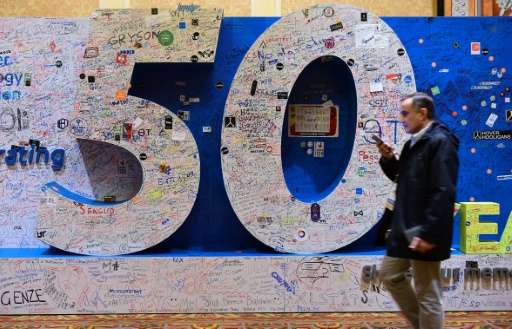 An attendee walks past a message board celebrating 50 years of the Consumer Electronic Show in Las Vegas, Nevada on January 8, 2