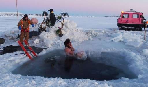An expeditioner stationed at Australia's Davis Station takes the plunge to celebrate the winter solstice