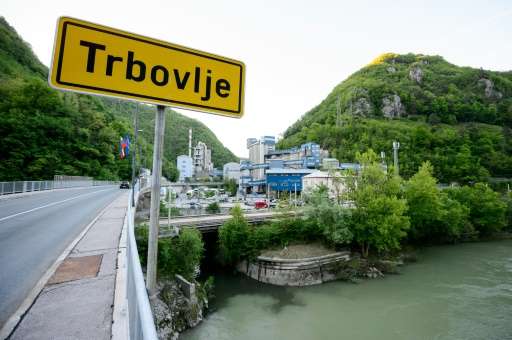 A picture shows a road sign indicating the entrance to the central Slovenian town of Trbovlje, with the Lafarge cement factory i