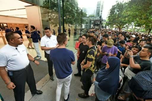 Around 300 customers waited overnight outside Singapore's Apple store, Southeast Asia's first to sell the new model