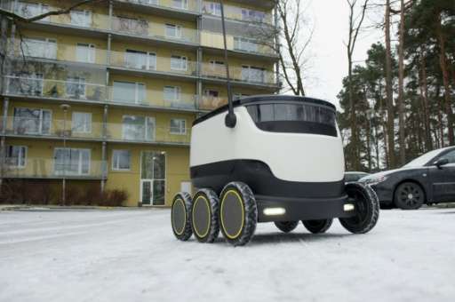 A six-wheeled robot by Starship Technologies makes its way to deliver food from a restaurant in Tallinn, Estonia