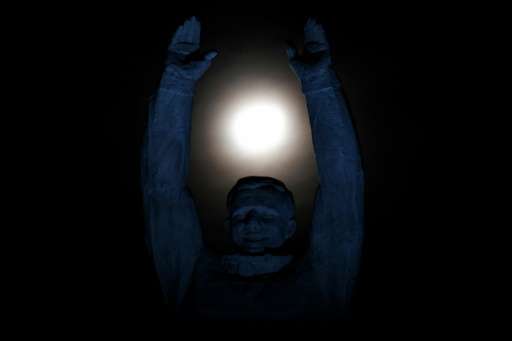 A statue of the first man in space, Russia's Yuri Gagarin, reaching for the moon