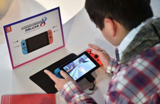 A visitor plays a Nintendo's new Switch game console during its game experience session in Tokyo on January 14, 2017