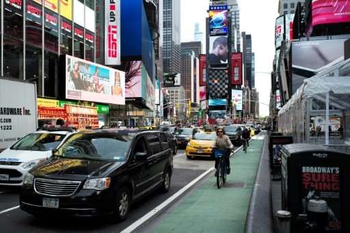 A woman rides in a dedicated bike lane in New York's Times Square