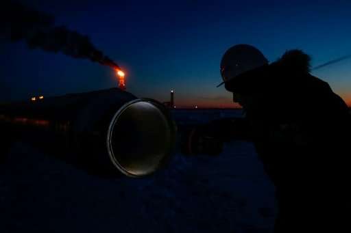 A worker inspects a pipe near the new LNG plant in the port of Sabetta in the Arctic circle