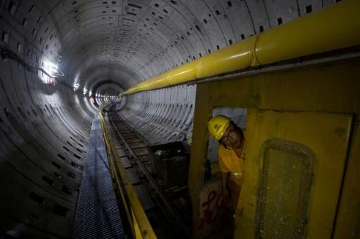 A worker looks out of a train at the construction site of Line 14 of the Shanghai metro system