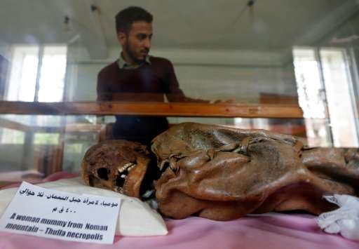A Yemeni student looks at a millennia-old mummy on display at Sanaa University