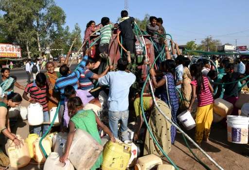 Bhopal residents collect drinking water from a truck, in central India