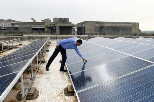 Chinmay Ghoroi, associate professor at the Indian Institute of Technology (IIT) Gandhinagar, next to roof-top solar panels at th