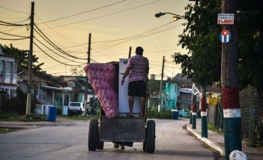 Cubans in the seaside town of Caibarien cart their belongings for safekeeping as they prepare for Hurricane Irma