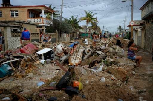 Debris lies piled in the streets of Cojimar in Havana after the passing of  Hurricane Irma on September 10, 2017