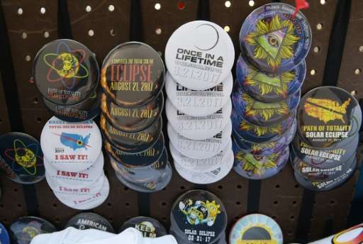 Eclipse pins are seen for sale on a street near the City Market in Charleston, South Carolina, on August 20, 2017