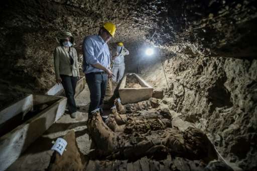 Egyptian Antiquities Minister Khaled el-Enany (C) speaks to media on May 13, 2017, in front of mummies discovered in catacombs i