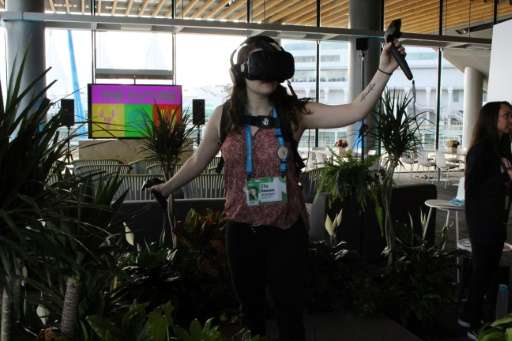 Ella Dawson experiences what it is like to be a tree in a rain forest faced with destruction in a virtual reality presentation a
