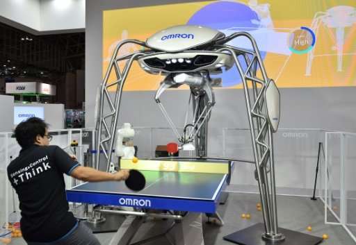 FORPHEUS, a fourth-generation table-tennis robot developed by automation parts maker Omron returns a shot to a human player at a