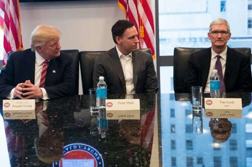 (From L) US President Donald Trump, Peter Thiel and Tim Cook, CEO of Apple, Inc., listen during a meeting with technology execut