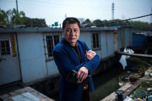 Garbage collector Li Chaoqing faces eviction along with about 200 other squatters living in decaying vessels on the Xinchapu Riv