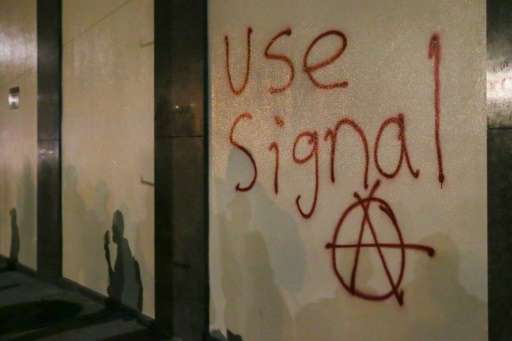 Grafitti urging people to use Signal, a highly-encrypted messaging app, is spray-painted on a wall during a protest in Berkeley,