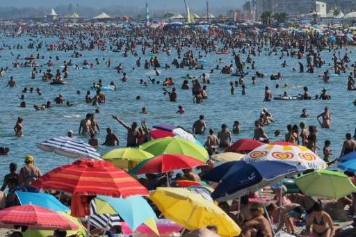 Holidaymakers seek to escape the heat taking to the beaches from southern France to Italy