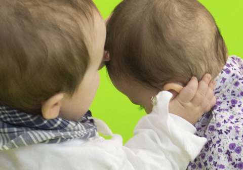 How do babies coordinate gestures and vocalization?