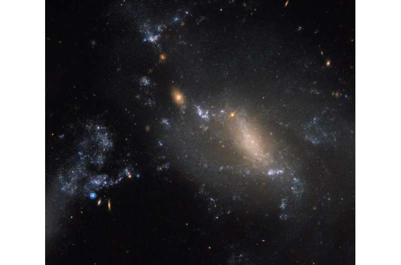Hubble spots two interacting galaxies defying cosmic convention