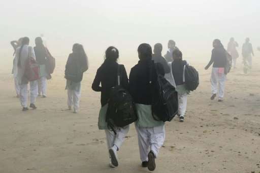 Indian schoolgirls walk to school in Amritsar after three days off due to severe smog