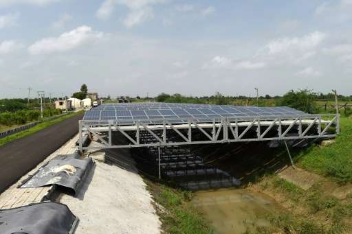India, the world's third-largest polluter, is banking on solar projects like these canal-top solar panels in Chandrasan village,