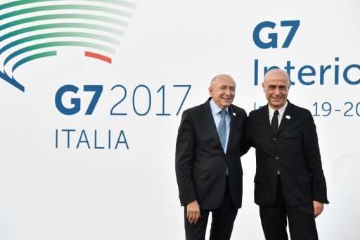 Italy's Interior Minister Marco Minniti (R) welcomes France's Interior Minister Gerard Collomb on October 19, 2017 for the G7 su