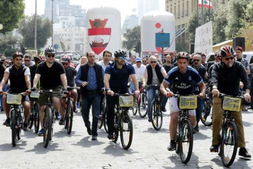 Lebanese Prime Minister Saad Hariri (C) rides a bike at an event to launch a public bicycle-sharing system in Beirut on April 30