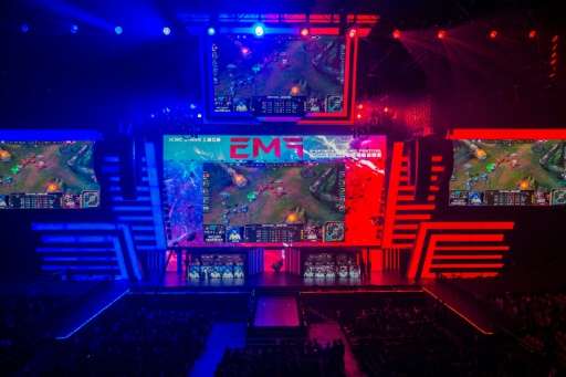 Members of team Hong Kong, Taiwan and Macau (centre R) and team Europe (centre L) compete on stage during the League of Legends 