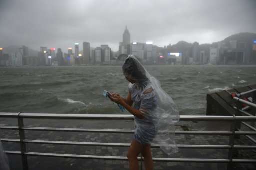 More than 120 were injured in Hong Kong as the territory was lashed with hurricane winds and pounding rain
