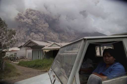 New eruption at Indonesia volcano spreads ash for miles