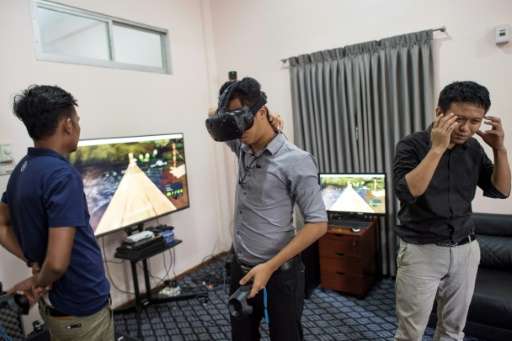 Nyi Lin Seck (R) uses virtual reality technology to preserve a digital replica of Myanmar's archaeological treasures