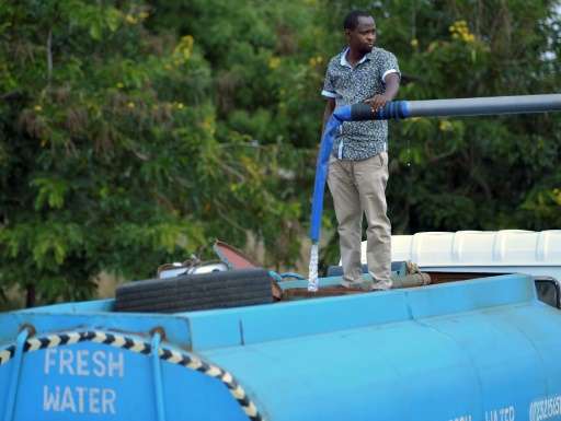 Patrick Kilonzo fills a hired bowser water tanker before embarking on a 70 kilometre journey to deliver the water to thirsty wil