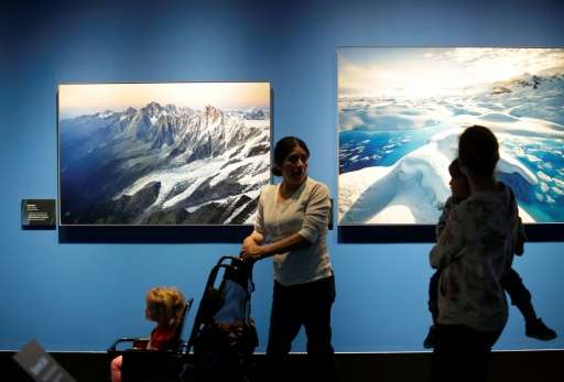 People attend the &quot;Extreme Ice&quot; exhibit by US photographer James Balog at the Museum of Science and Industry in Chicag