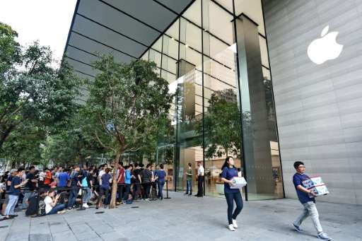 People queue outside the Apple store in Singapore's Orchard shopping district on its opening day, on May 27, 2017