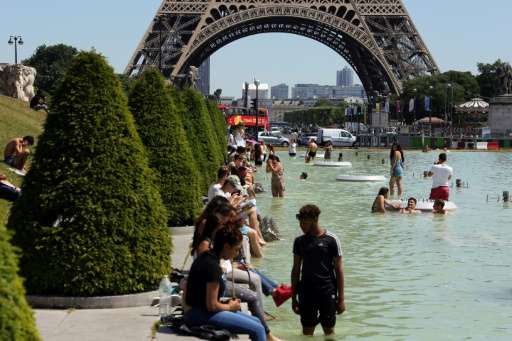 People refresh themselves in the Trocadero fountain in Paris, on June 19, 2017, as the French capital is placed on heatwave aler