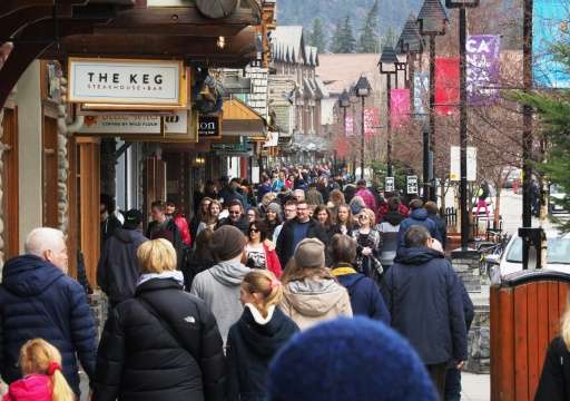 People stroll through the town of Banff inside Banff National Park, Alberta. Canada's national parks contribute Can$1.5 billion 