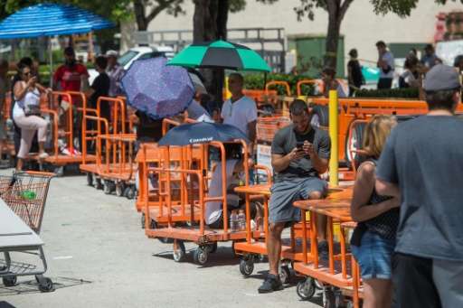 People waited in line to purchase supplies outside a Home Depot store in Miami, as they prepared for Hurricane Irma