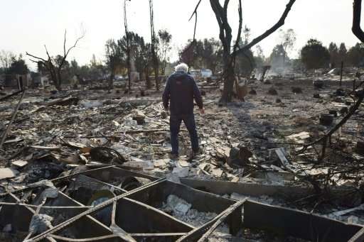 Phil Rush looks at the remains of his home destroyed by fire in Santa Rosa, California