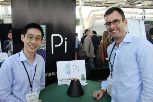 Pi co-founders Lixin Shi, left, and John MacDonald tout their invention as the world's first wireless charger that does away wit