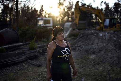 &quot;We lost everything,&quot; said Edite Godinho, watching a bulldozer demolish the charred remains of her home in Vale da Nog