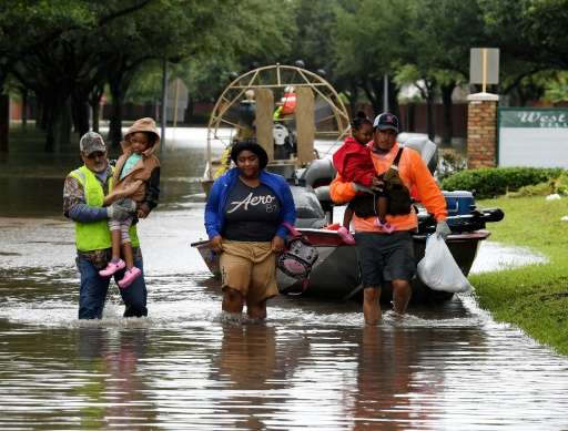 Residents were evacuated on an air boat operated by volunteers from San Antonio, in Houston's Clodine district