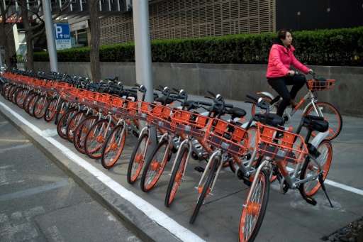 Soaring numbers of cyclists are causing problems in China's cities because many simply leave the bikes in the middle of sidewalk