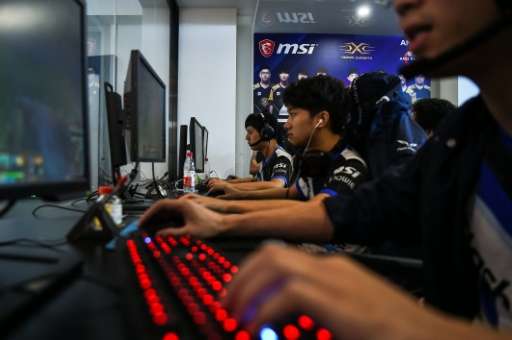 Taiwanese gamers from the eSports team Flash Wolves play during training for the League of Legends World Championship, at a boot