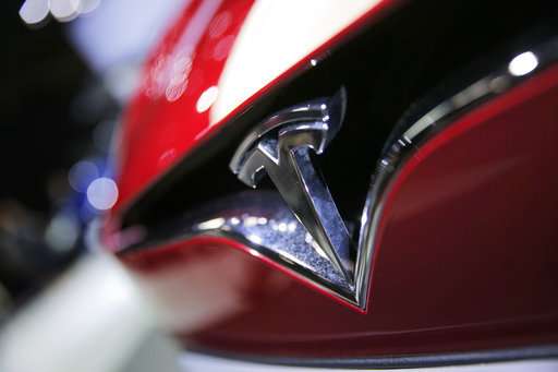 Tesla swings to $671m loss on Model 3 delays