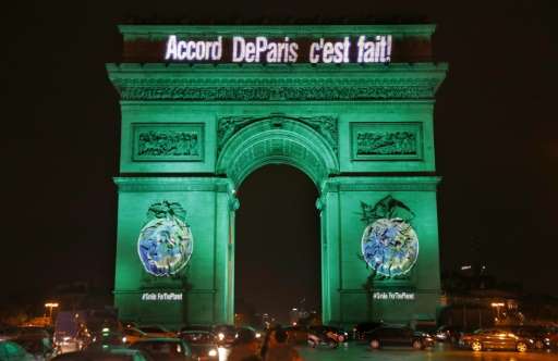 The Arc de Triomphe is illuminated with the lettering reading &quot;The Paris accord is done&quot; in Paris on November 4, 2016,