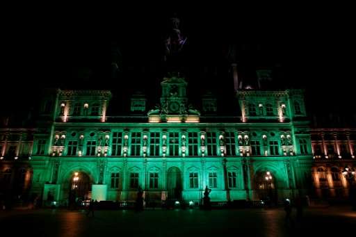 The City Hall of Paris illuminated in green following the announcement by US President Donald Trump that the United States will 