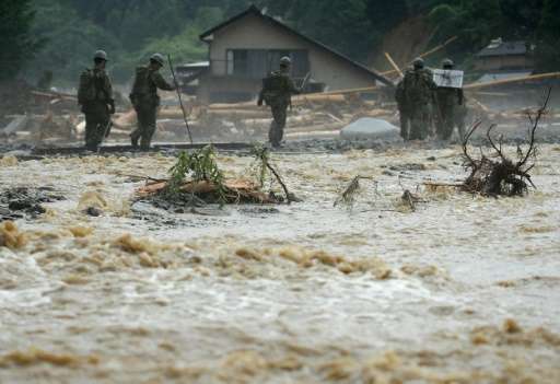 The death toll from heavy rains and flooding in southern Japan has risen to 18